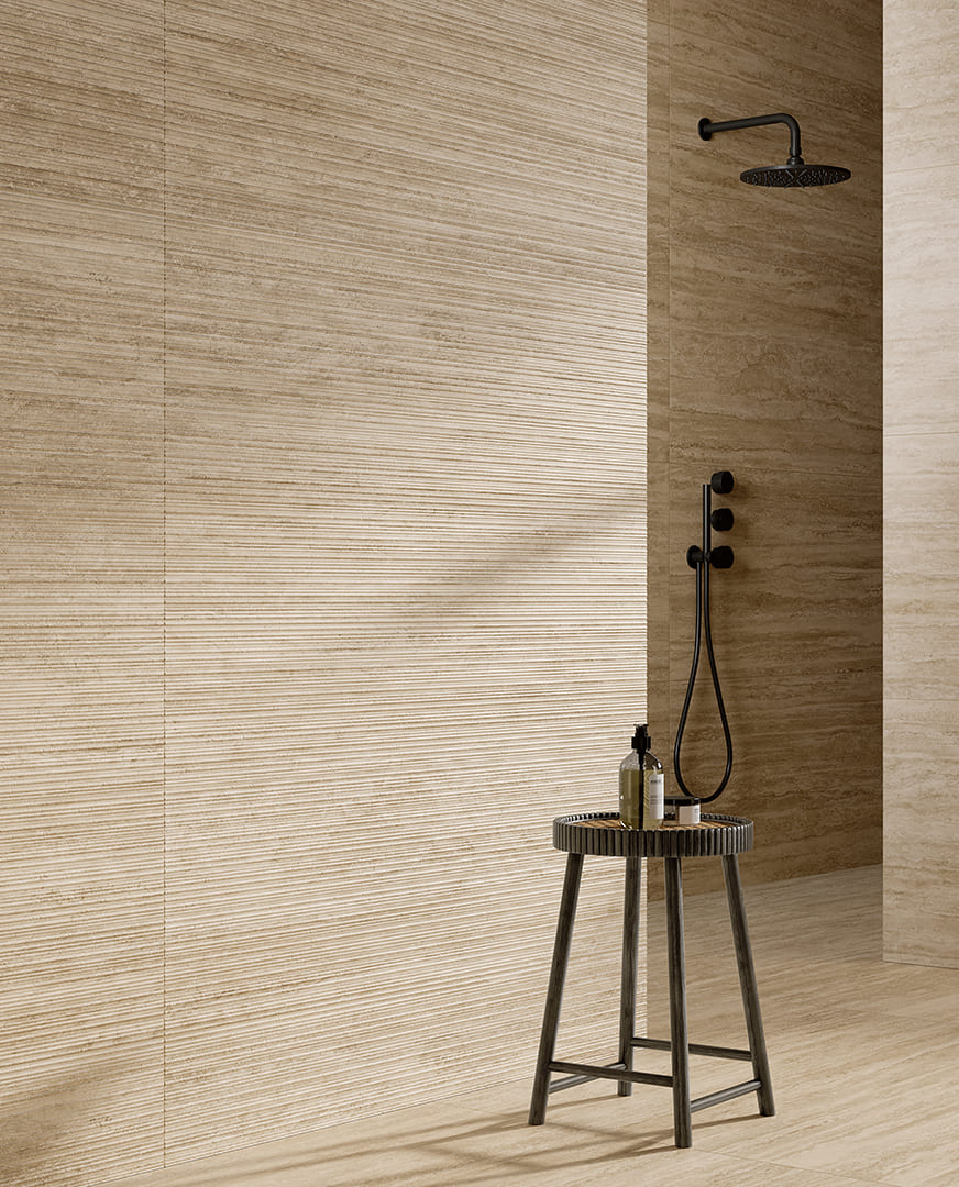 Sfeerbeeld van Pastorelli New Classic met beige travertinlook en fijne lijnen op de douchewand